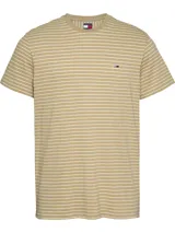 Remera Tommy Jeans de corte slim, color beige con rayas horizontales blancas. Tiene cuello redondo y logo bordado en el pecho.