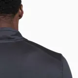 Buzo gris de poliéster reciclado y spandex, con cuello alto y cierre de cremallera hasta el pecho. Tiene mangas largas con orificios para los pulgares y logo de la marca en el pecho.