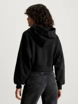 Buzo cropped negro con capucha, confeccionado en felpa de mezcla de algodón regenerativo, con cierre de cremallera metálico.