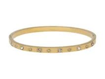 Pulsera rígida dorada con diseño de flores y cristales.