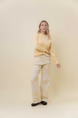 Pantalón de jean de pierna ancha y tiro medio-alto, con estampado suave en tonos amarillos y blancos.