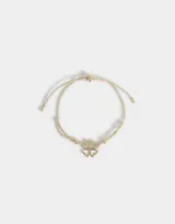 Pulsera dorada con cordón ajustable y dije de trébol con strass.
