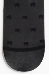 Medias can can negras con cintura elástica y estampado de moñas.