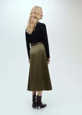 Vestido midi evasé color verde oliva, confeccionado en lyocell con efecto satinado. Presenta cuello barco, mangas largas y cinturón decorativo con hebilla metálica.