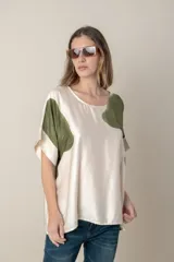 Blusa italiana color natural con estampado de hojas grandes en tonos marrones. Tiene cuello redondo y mangas cortas amplias.