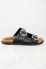 Sandalias negras de cuero con hebillas plateadas ajustables y plantilla de corcho.