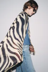 Pañuelo rectangular de modal con estampado de cebra en tonos beige y negro, y terminaciones desflecadas.