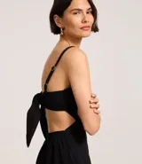 Mono largo color blanco, de breteles finos y escote recto. Presenta recorte cut-out en la cintura y lazo en la espalda.