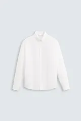 Camisa blanca de corte relaxed fit, confeccionada en tejido de lino y algodón. Tiene cuello abotonado, manga larga con puños abotonados, bolsillo en el pecho y cierre frontal con botones.