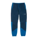 Pantalón de jogging Columbia de nylon azul marino con paneles laterales en azul eléctrico. Cuenta con cintura elástica ajustable con cordón, bolsillos laterales y logo de la marca bordado en la pierna derecha.