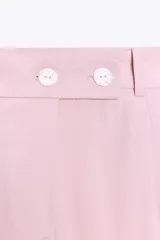 Pantalón ancho color rosa claro, de tiro alto con pinzas delanteras, bolsillos frontales y cierre frontal con cremallera y botones.