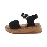 Sandalias marrones con plataforma de corcho, tira ancha sobre el empeine y pulsera al tobillo con hebilla dorada.