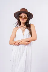 Vestido largo negro con escote en V, breteles finos y falda amplia con volado en el ruedo.