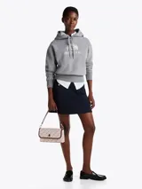 Buzo gris melange de Tommy Hilfiger con capucha y cordón ajustable. Logotipo bordado en el pecho y en la manga.