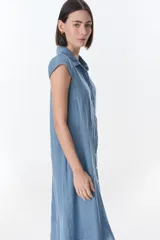 Vestido camisero celeste de lino, corte midi, con cuello camisero, mangas cortas con volados y abotonadura frontal.