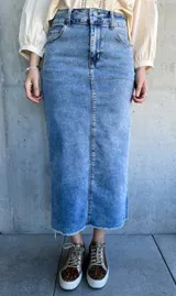 Falda midi de jean celeste con abertura trasera y terminación desflecada.