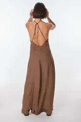 Conjunto de top halter con abertura en el abdomen y falda cruzada con ruedo desflecado, color fucsia.