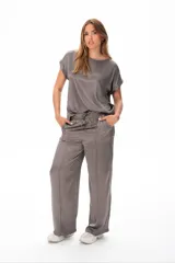 Conjunto deportivo gris compuesto por remera de mangas cortas y pantalón palazzo con cintura elastizada y cordón ajustable.