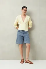 Bermuda de jean azul de corte clásico y largo a la rodilla.