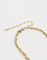 Collar corto multicadena con strass, eslabones y margaritas de metal.