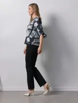 Blusa de gasa color blanco con estampado de hojas verdes, de mangas 3/4 abullonadas con puños elásticos.