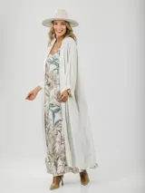 Vestido largo de tirantes finos con estampado floral en tonos beige y verde.