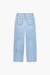 Pantalón denim celeste de tiro medio con cintura ajustable con cordones, bolsillos laterales y de plastrón en espalda. Cierre frontal con cremallera y gancho metálico.