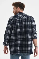 Sobrecamisa a cuadros azul marino y gris, de corte recto y manga larga, con cuello camisero y cierre frontal con botones.