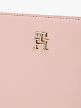 Bandolera Tommy Hilfiger color rosa con correa ajustable y logo dorado en el frente.