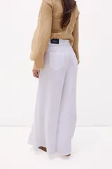 Pantalón celeste de lino, de corte amplio y tiro alto.