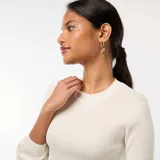 Sweater blanco de tejido de punto de canalé, con cuello redondo y mangas largas.