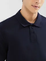Camiseta tipo polo de manga corta, color azul oscuro, con cuello y tapeta de dos botones.