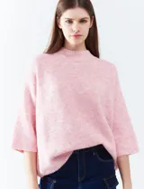 Buzo rosa de tejido melange, marca Q2, con cuello alto y mangas 3/4.