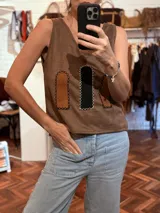 Chaleco marrón de tela agamuzada con apliques cortados y bordados a mano.