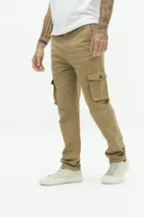 Pantalón cargo color beige, sin puños, con cuatro bolsillos con botón y pasa cintos.