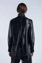 Camisa negra de cuero sintético con cuello clásico con solapas y cierre frontal con botones.