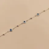 Pulsera de plata 925 con dije de ojo turco celeste y bolitas plateadas.