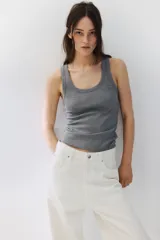 Musculosa gris de punto de algodón acanalado, con cuello redondo y sisas anchas.