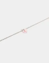 Cadena dorada con dije de corazón facetado color lila.