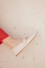 Chatitas tipo Mary Jane de charol negro con punta redondeada y tira sobre el empeine con hebilla metálica plateada.