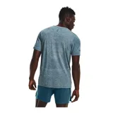 Remera deportiva gris jaspeado de corte clásico, con cuello redondo y mangas cortas. Confeccionada con tejido de punto transpirable y tecnología seamless para mayor comodidad.