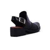 Zueco negro con hebilla plateada, taco ancho y suela track.