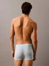 Pack de tres bóxers Calvin Klein de algodón elástico en azul, celeste y gris, con cintura elástica con el logo de la marca.