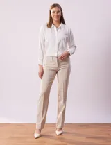 Pantalón de vestir color beige, de corte recto, con bolsillos laterales y traseros. Se ajusta a la cintura con broches internos y cierre.