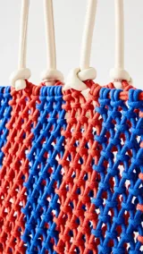Bolso tote bag de crochet casual en rayas rojo y azul, con asas largas.