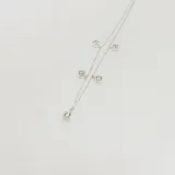 Tobillera de plata 925 con cadena fina y cinco dijes colgantes: dos con forma de lágrima y tres con forma cuadrada, todos engastados con circones brillantes.