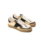 Zapatillas urbanas doradas con detalles en negro y suela color caramelo.