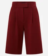 Bermuda de sastrería color borgoña, con cierre descentrado, trabillas en la cintura y pliegues delanteros.