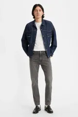 Pantalón de jean gris oscuro, corte skinny, tiro medio y confeccionado en tejido rígido.