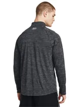Buzo deportivo Under Armour Tech Texturd Hlf Zip para hombre, color azul jaspeado, de calce suelto, liviano y con cierre medio en el cuello. Cuenta con tecnología UA Tech™ que mantiene la frescura.